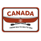 Canada sticker with the word 'Canada' and an illustration of a red canoe with a Canadian flag, two crossed paddles and the phrase 'from sea to sea to sea'.